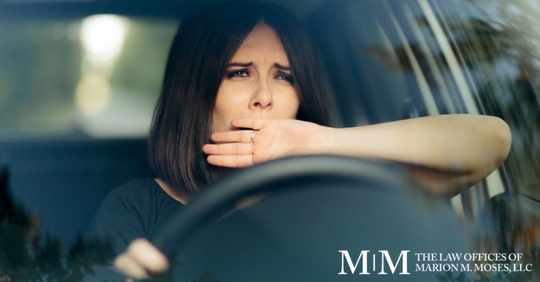 woman yawning while driving a car